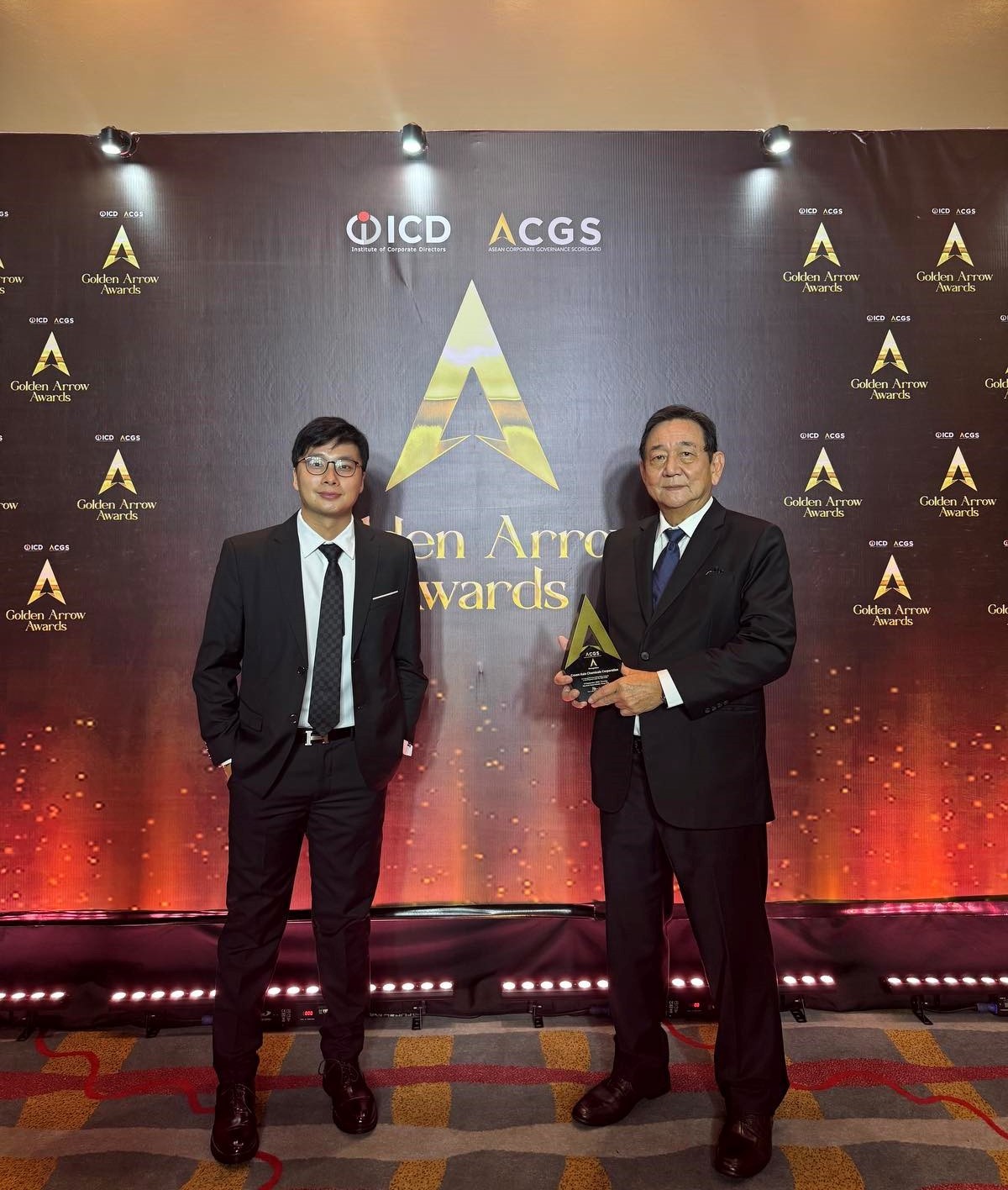 CROWN representatives receiving the Golden Arrow Award on stage